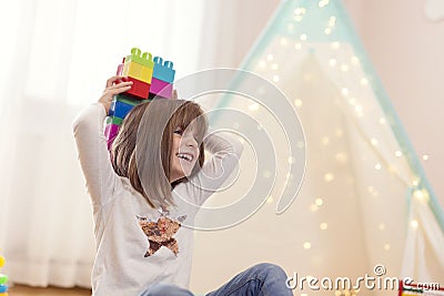 Cute little girl playing with building blocks Stock Photo