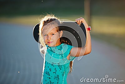 Cute little girl with skateboard Stock Photo