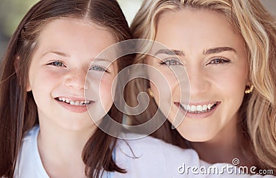 Cute little girl smiling while taking selfies and bonding with her mother at home. Caring and loving mother relaxing Stock Photo