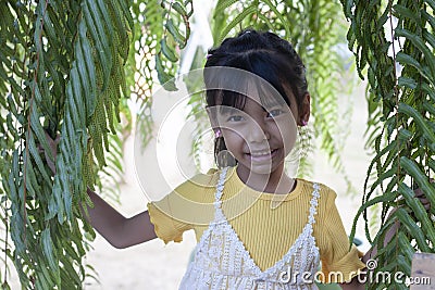Cute little girl standing and smile in the garden. Stock Photo