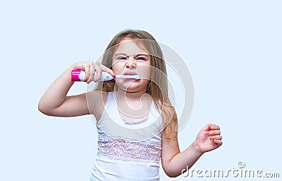 Cute little girl with a toothbrush in her hand cleans her teeth Stock Photo