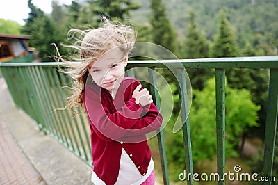 Cute little girl on a very windy day Stock Photo