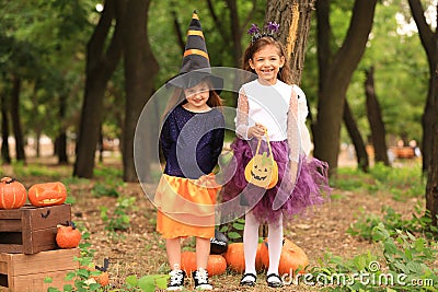 Cute little girls dressed for Halloween in autumn park Stock Photo