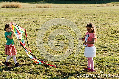 Cute little girls flying a kite Editorial Stock Photo