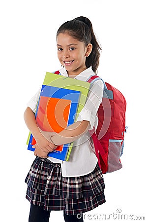 Cute little hispanic school girl carrying schoolbag backpack and books smiling Stock Photo