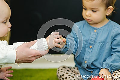 Cute little kids in nursery play with balls and smile Stock Photo