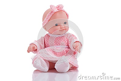 Cute little plastic baby doll with blue eyes sitting isolated o Stock Photo