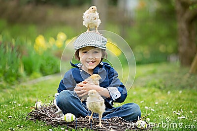 Cute little preschool child, boy, playing with easter eggs and c Stock Photo