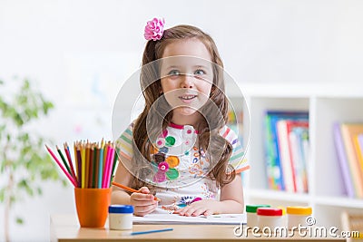 Cute little preschooler child drawing at house Stock Photo