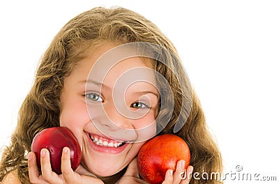 Cute little preschooler girl holding two peaches Stock Photo
