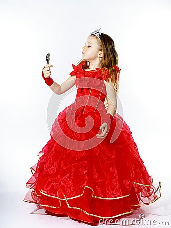 Cute little princess dressed in red isolated on white background Stock Photo