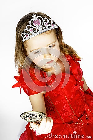 Cute little princess dressed in red isolated on white background Stock Photo