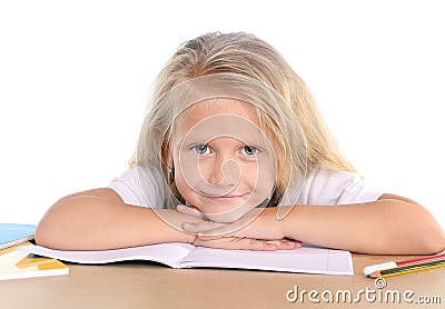 Cute little school girl happy on desk leaning in relax on book Stock Photo