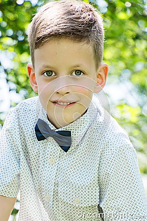 Cute little stylish boy in classic style in park Stock Photo