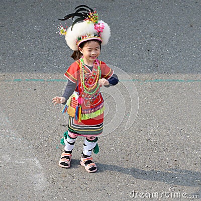 Cute little Taiwanese girl in garb of Amis Tribe from Hualien Matain with headdress and skirt, Kaohsiung, Taiwan Editorial Stock Photo