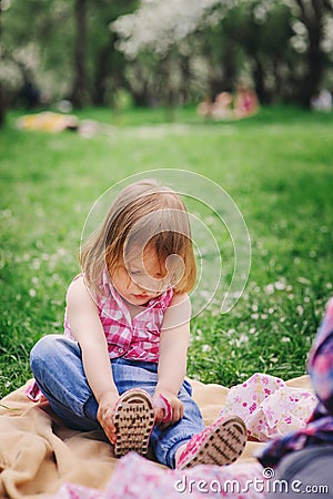 Cute little toddler girl getting dressed Stock Photo