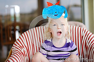 Cute little toddler girl with a self made puppy mask Stock Photo