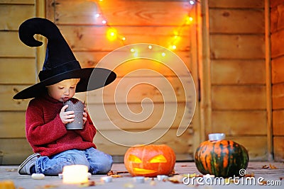 Cute little wizard looking on candle Stock Photo