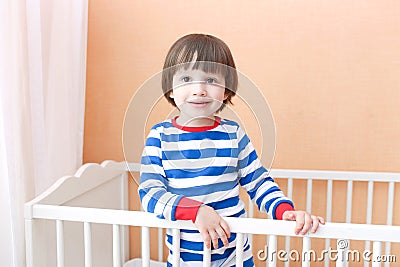 Cute little 2 years child standing in bed at home Stock Photo