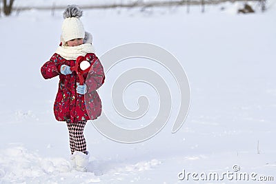 Cute little young funny toothless child girl in warm clothing pl Stock Photo