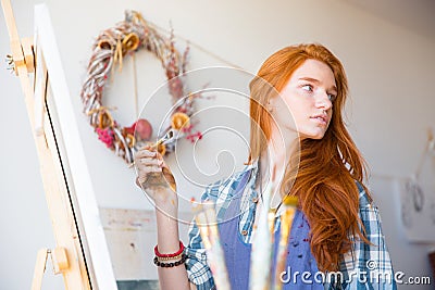 Cute lovely young woman painter working in art workshop Stock Photo