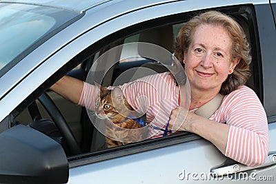 Cute mature female driver with her cat Stock Photo