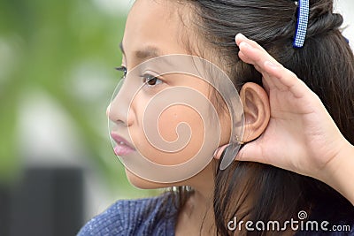 Cute Minority Teenage Female Listening Stock Photo
