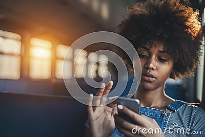 Cute mixed girl in train chatting via smartphone Stock Photo