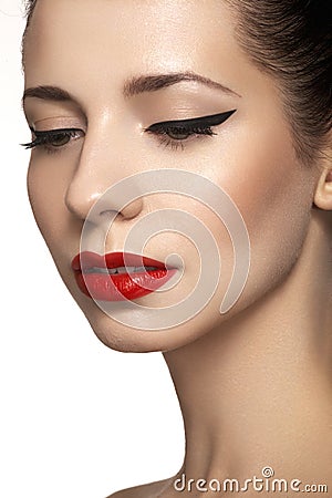 Cute model face with bright classical evening make-up, eyeliner on eyes, red lipstick Stock Photo
