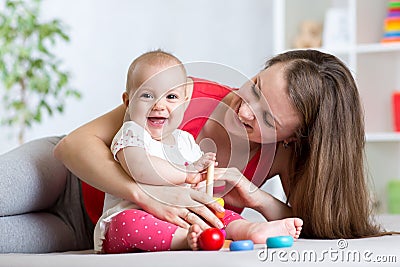 Cute mother and baby play indoor at home Stock Photo