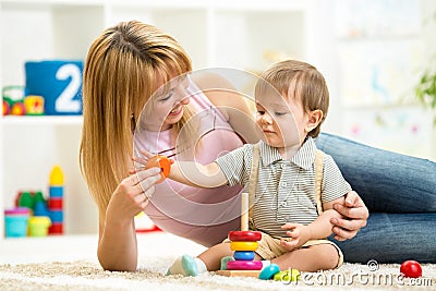 Cute mother and child boy play together indoor at Stock Photo