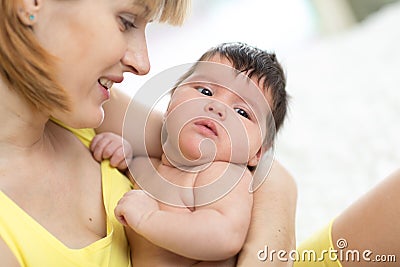 Cute mother holding her newborn child. Mom nursing baby. Stock Photo