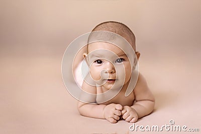 Cute newborn baby girl lying on simple beige background Stock Photo