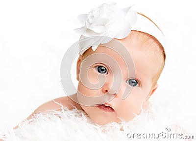 Cute newborn baby girl with a pink flower ribbon Stock Photo