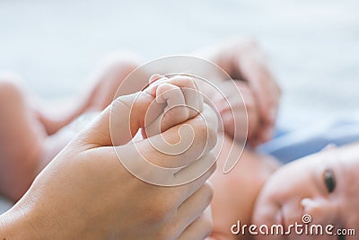 Cute newborn baby hold mother by the thumb Stock Photo