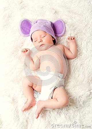 Cute newborn baby sleeps in a hat with ears Stock Photo