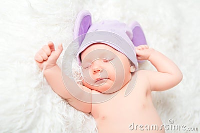 Cute newborn baby sleeps in a hat with ears Stock Photo