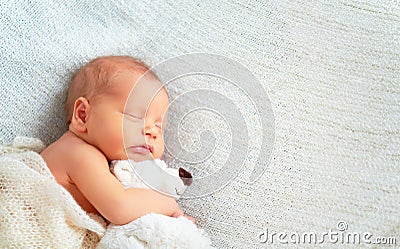 Cute newborn baby sleeps with toy teddy bear Stock Photo