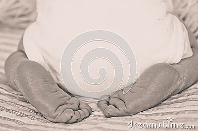 Cute newborn infant baby boy asleep wrapped in a soft plaid. Parts of the body of a small child. Love baby Stock Photo