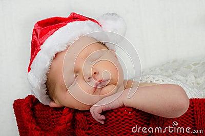Cute newborn infant wearing santa hat for christmas Stock Photo