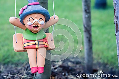 Cute old woman clay doll decorate in the garden Stock Photo