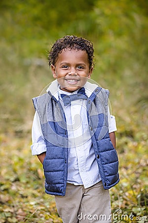 Cute outdoor portrait of a smiling African American boy Stock Photo