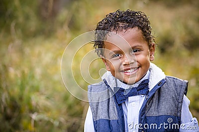 Cute outdoor portrait of a smiling African American young boy Stock Photo