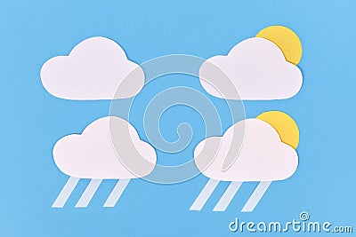 Paper weather icons with cloud, rain and partial sun on blue background Stock Photo