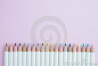 Cute pastel color pencils on pink paper background with copy spa Stock Photo