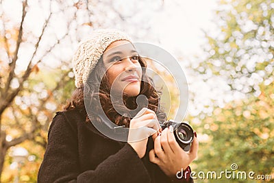 Cute photographer looking at autumn trees Stock Photo
