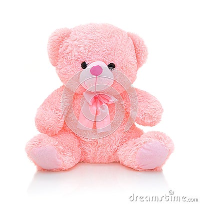 Cute pink bear doll with bow on white background with shadow reflection. Playful bright pink bear. Stock Photo