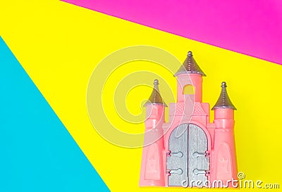 Cute pink Castle toy on blue, yellow and pink background Stock Photo