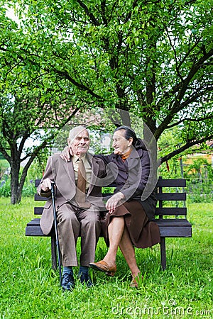 Cute 80 plus year old married couple posing for a portrait in their garden. Love forever concept Stock Photo