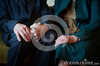 Cute 80 plus year old married couple posing for a portrait in their house. Love forever concept Stock Photo